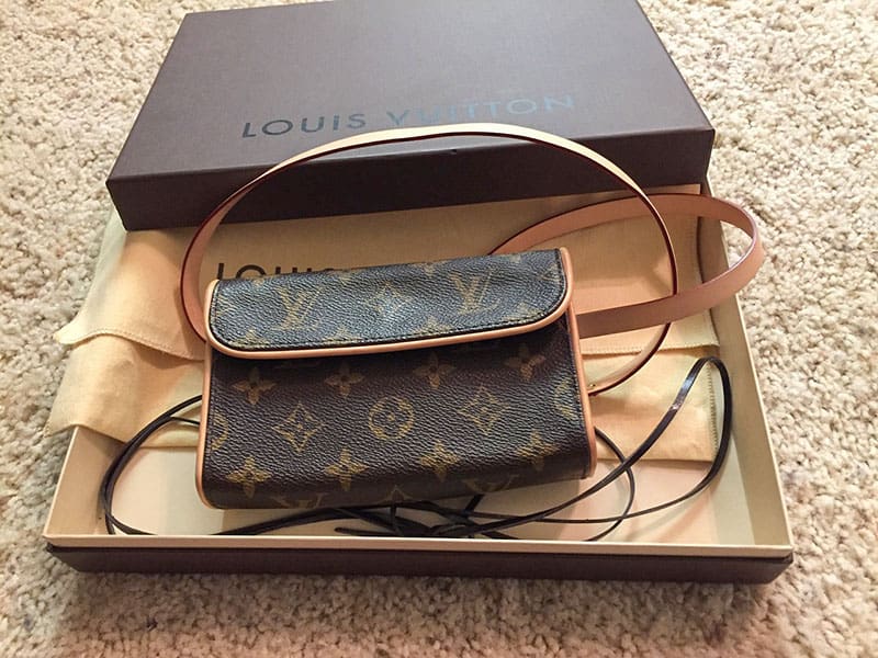 A Louis Vuitton monogram purse with dust bag and box