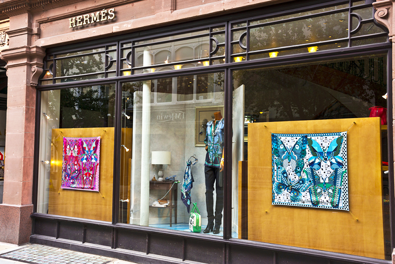 A window display of silk scarves at Hermes