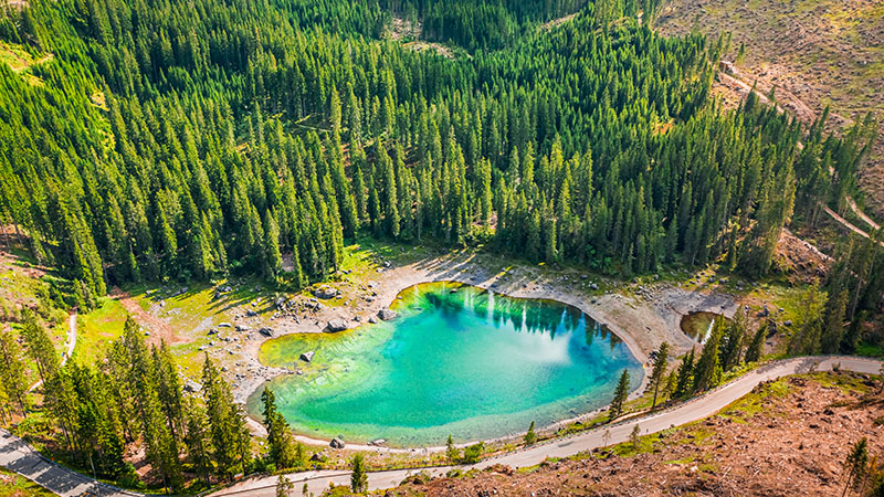 Aerial view of stunning Carezza lake in Dolomites, Italy